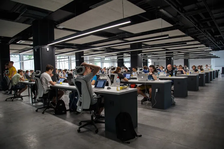 Large open office with engineers working at rows of desks